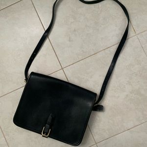 Black leather crossbody bag with gold buckle